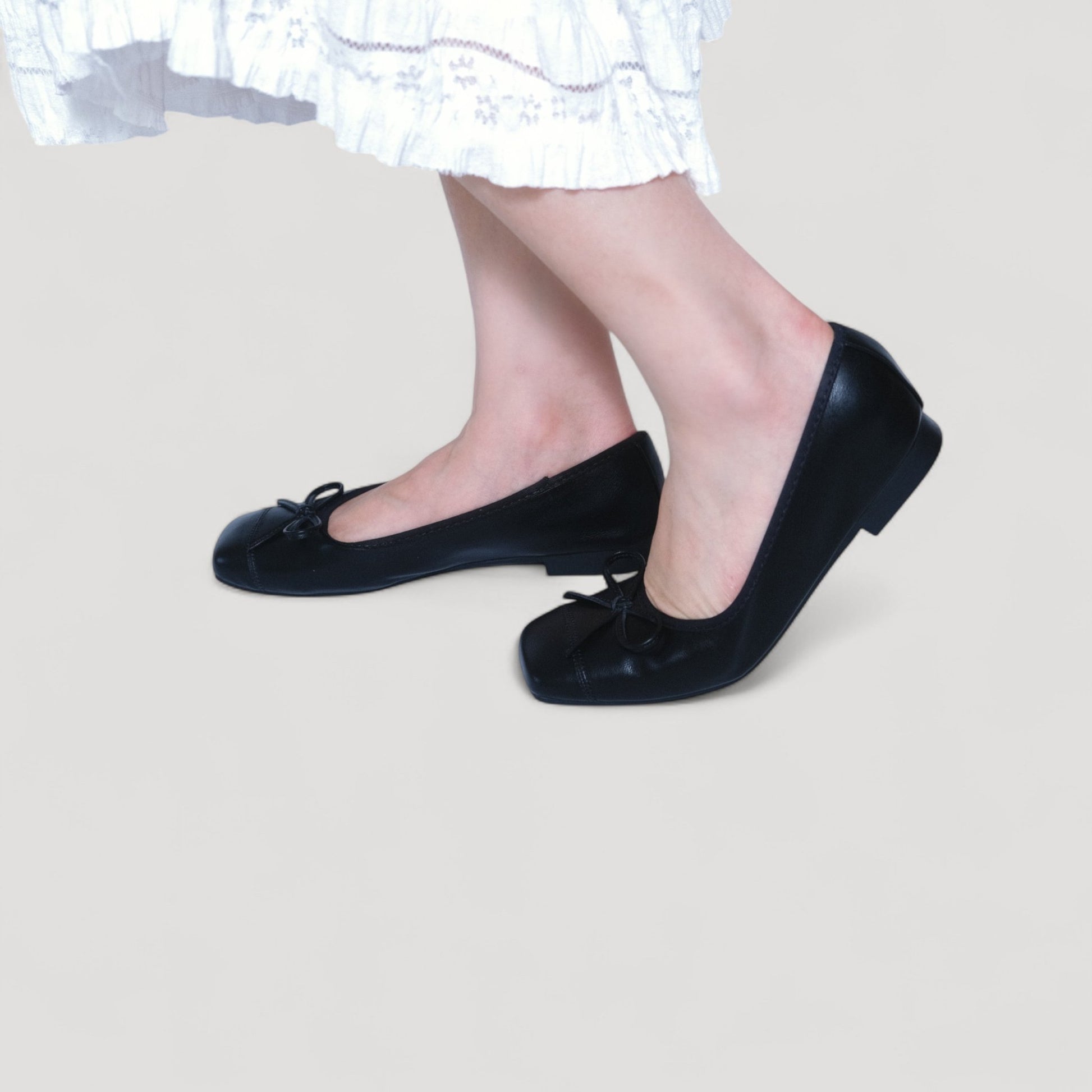 black bow square toe leather ballet flats model walking view
