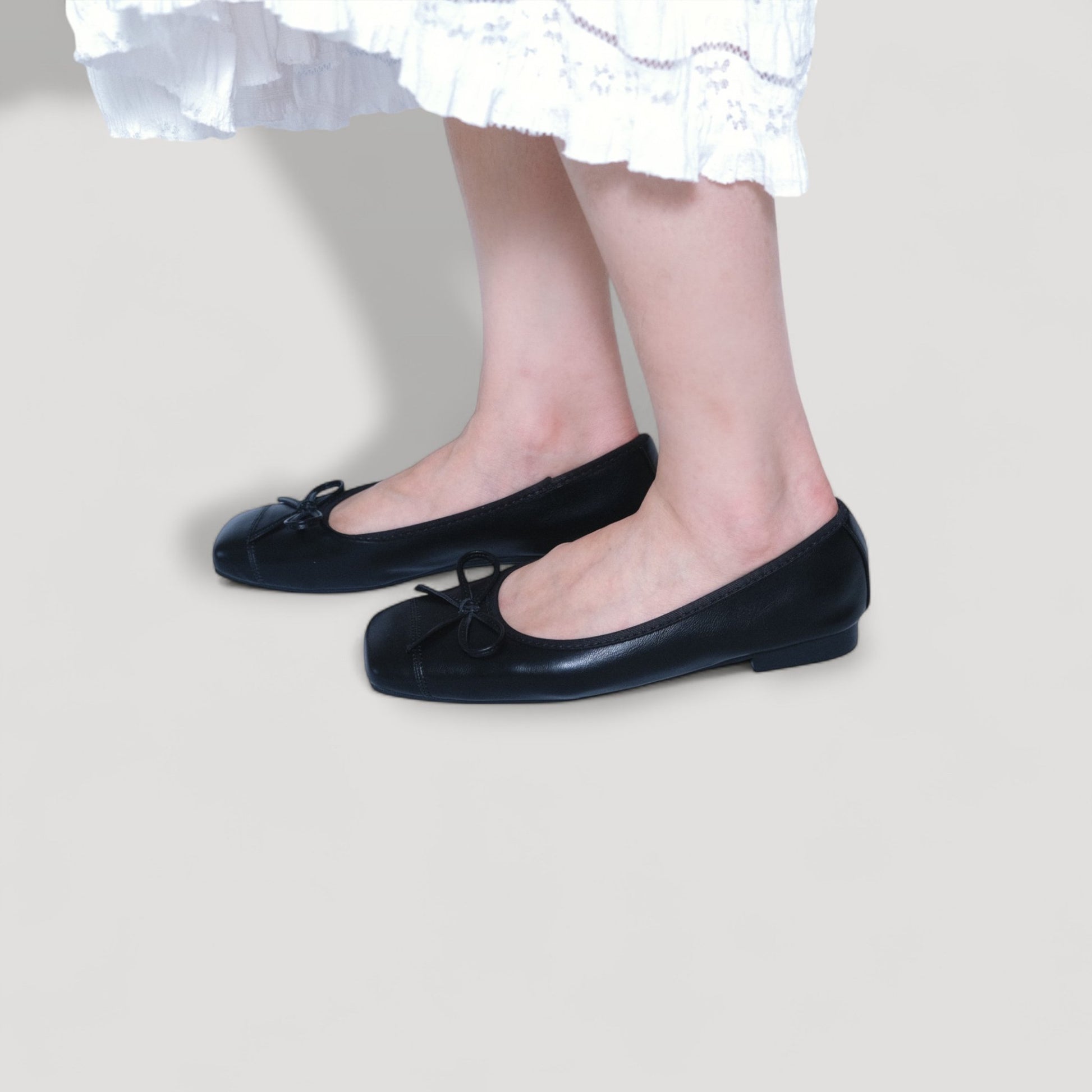 black bow square toe leather ballet flats model standing view