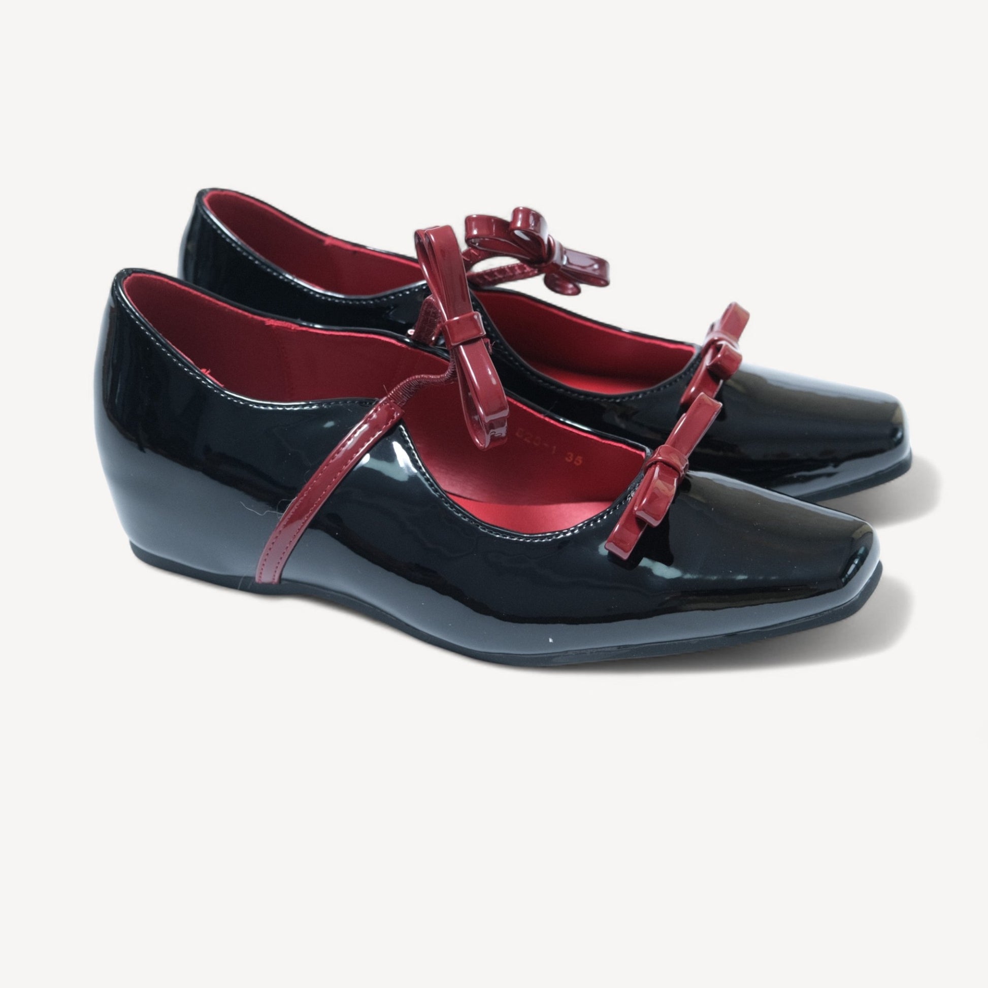 black patent mary jane bow flats oblique view