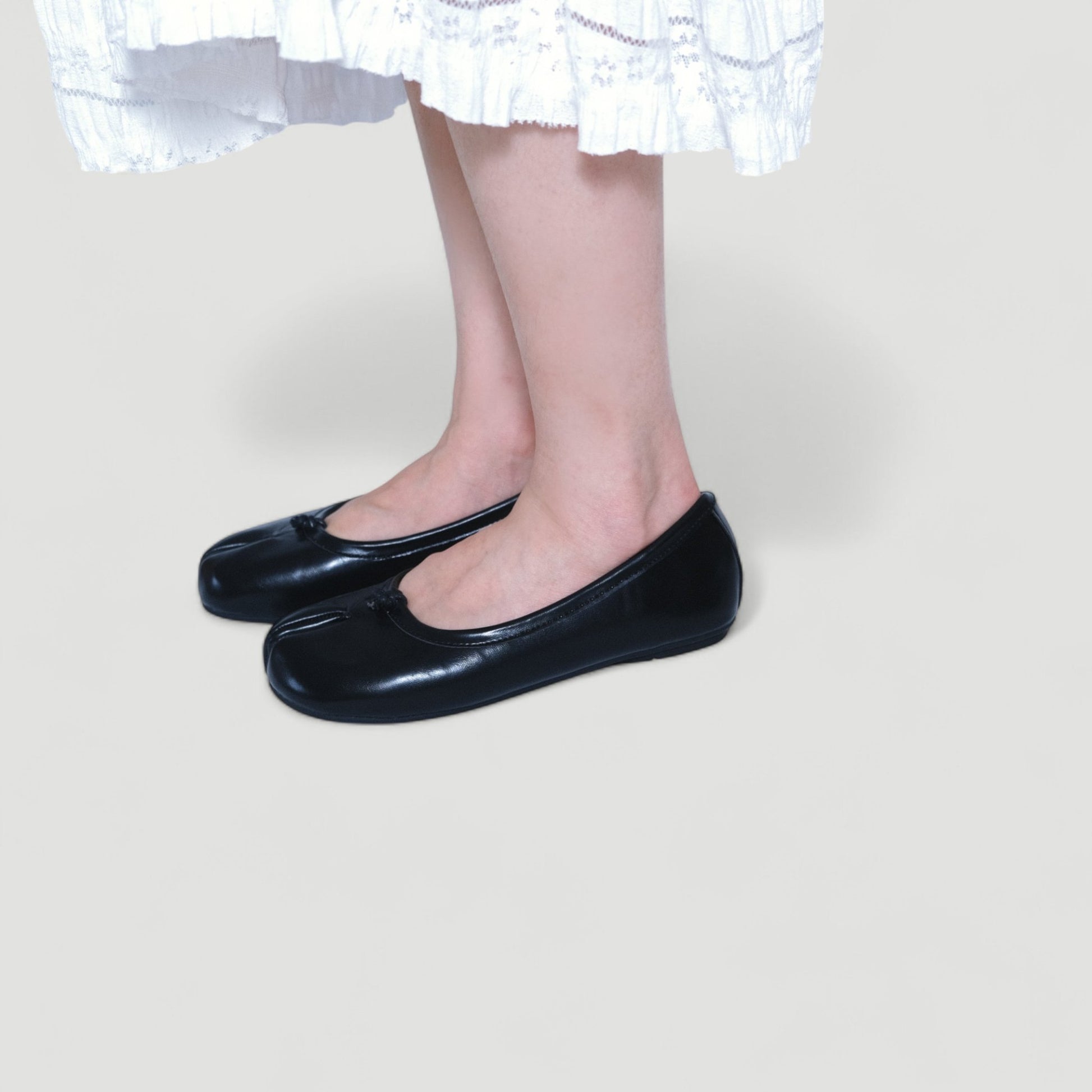 black split toe leather flats tabi model standing