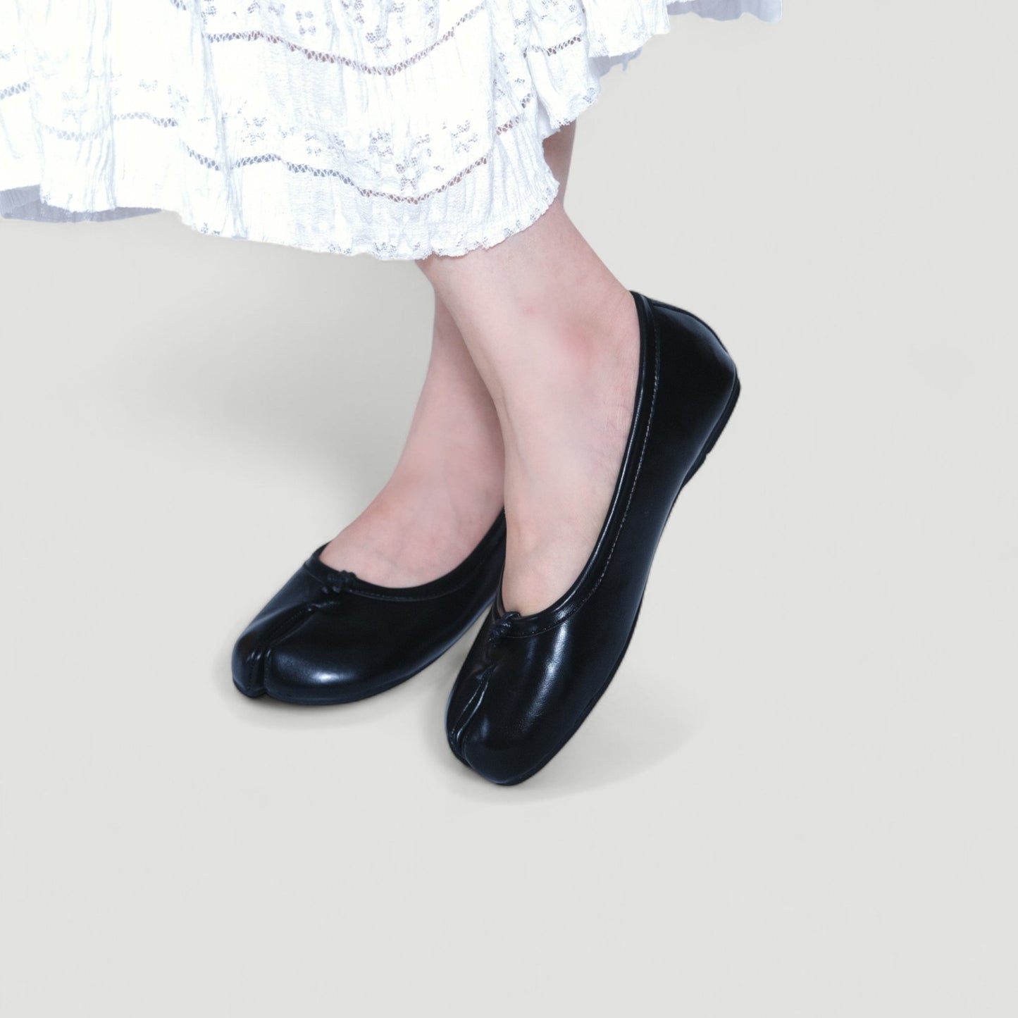 black split toe leather flats tabi model posing