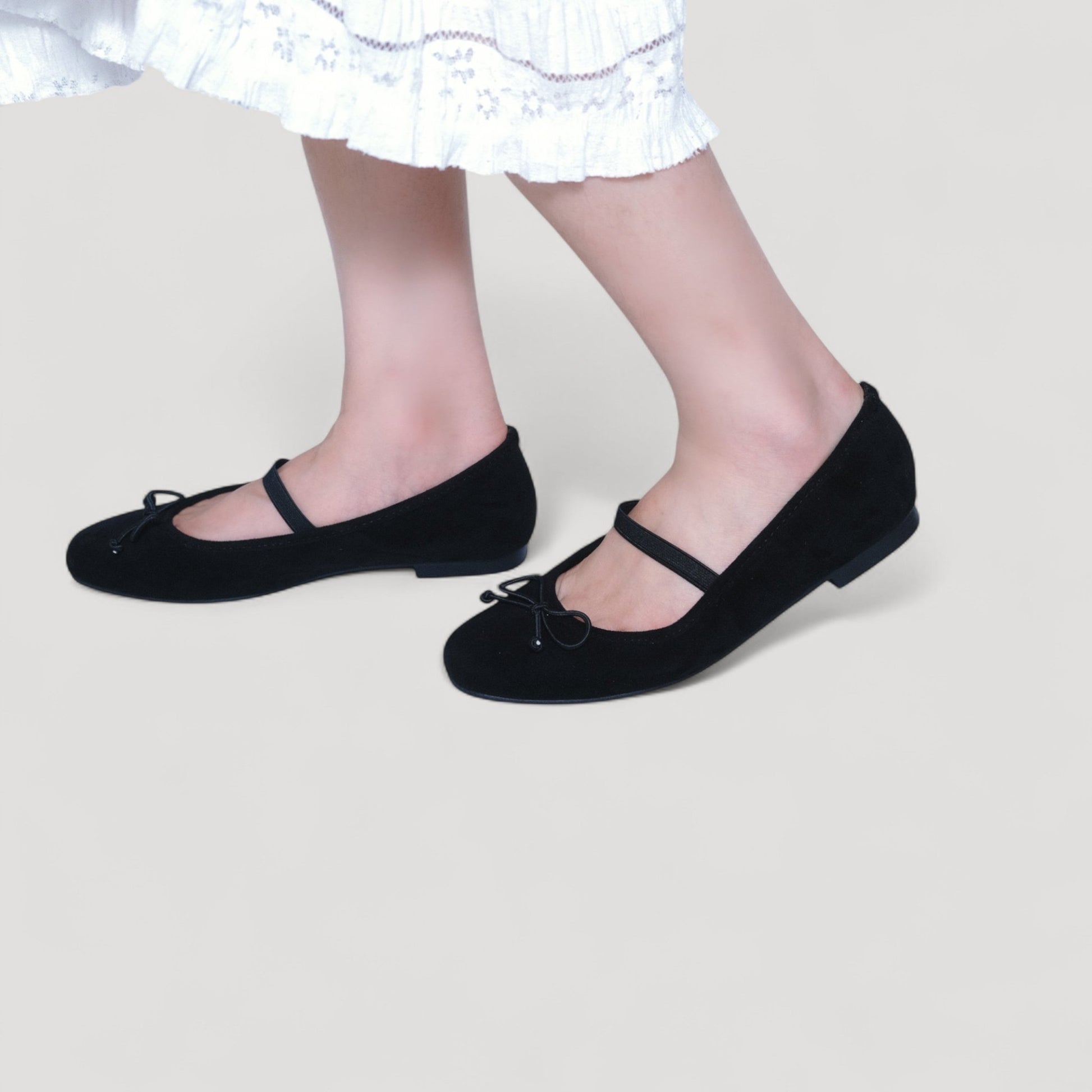 black suede almond toe flats model walking view