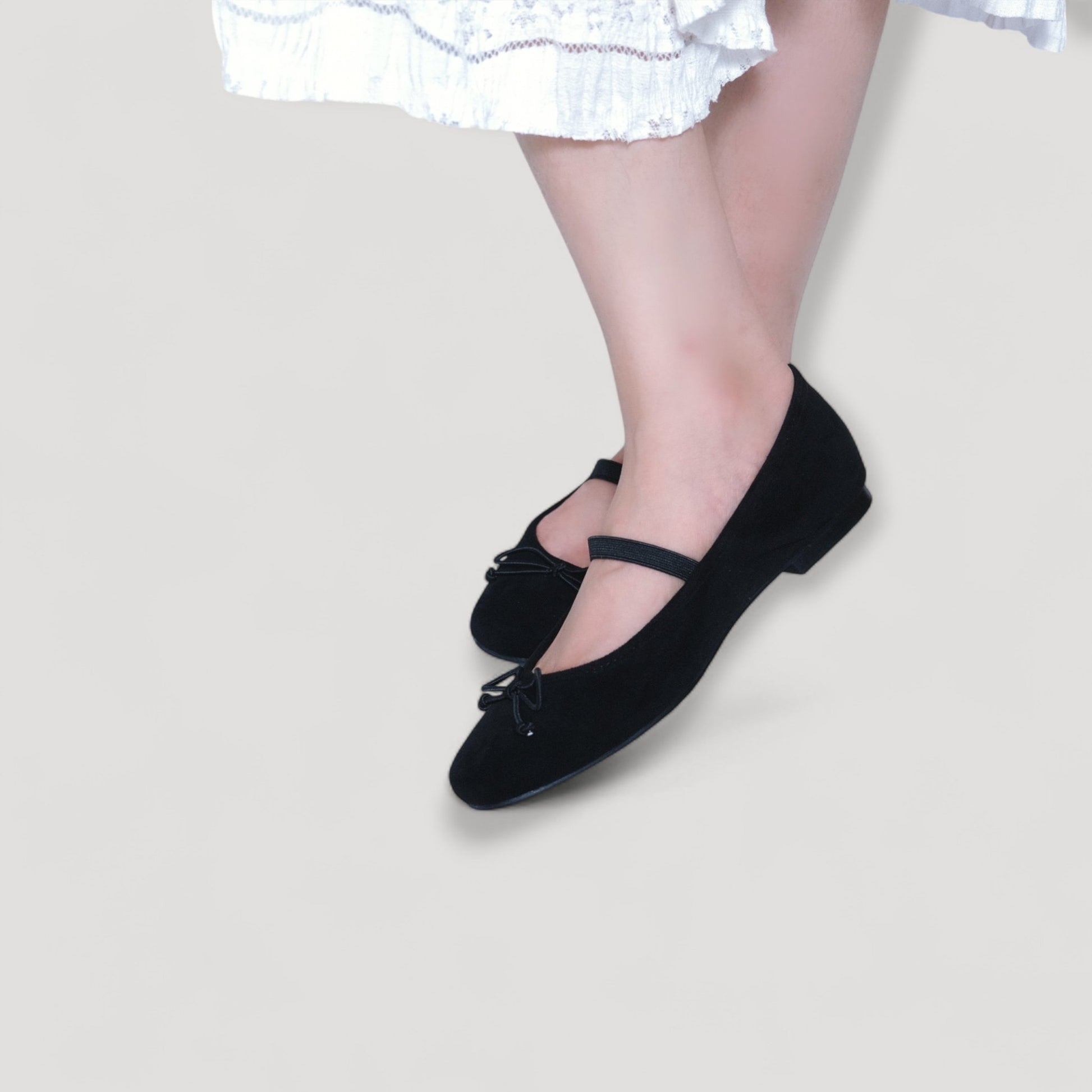 black suede almond toe flats model posing view