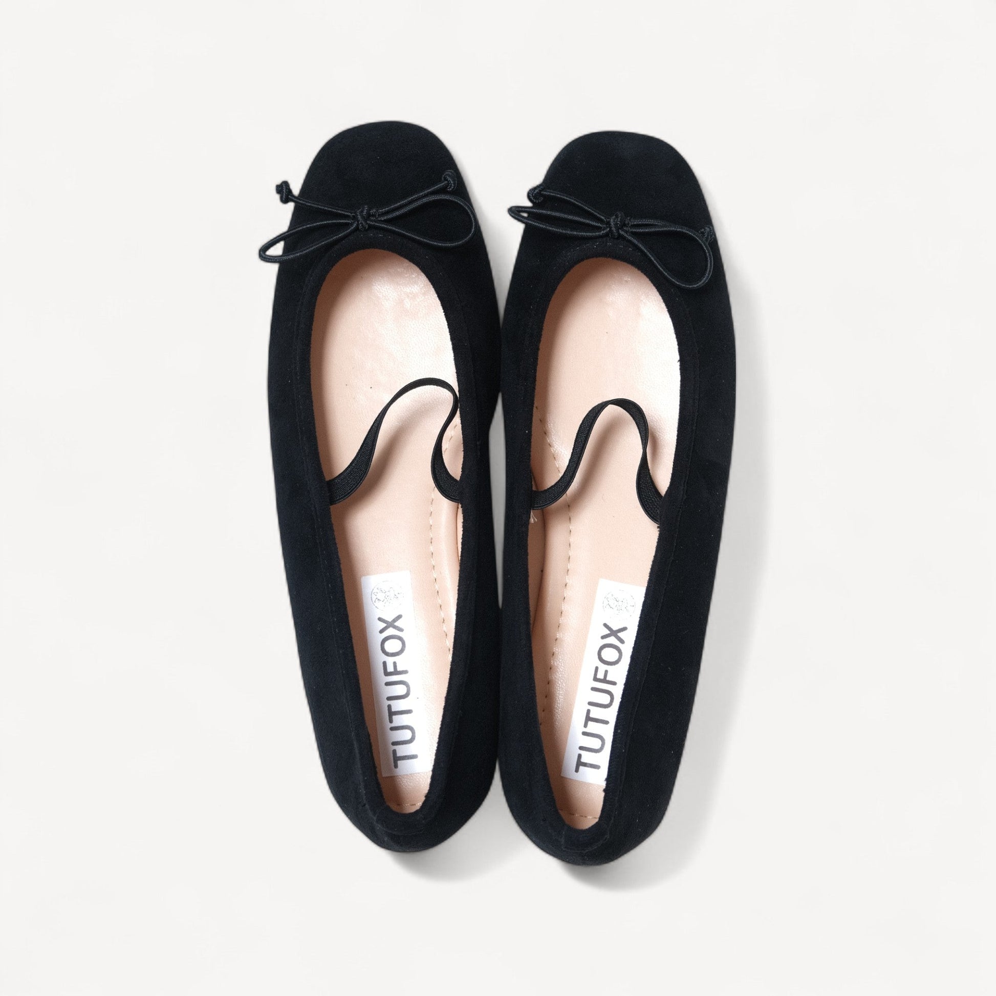 black suede almond toe flats front view