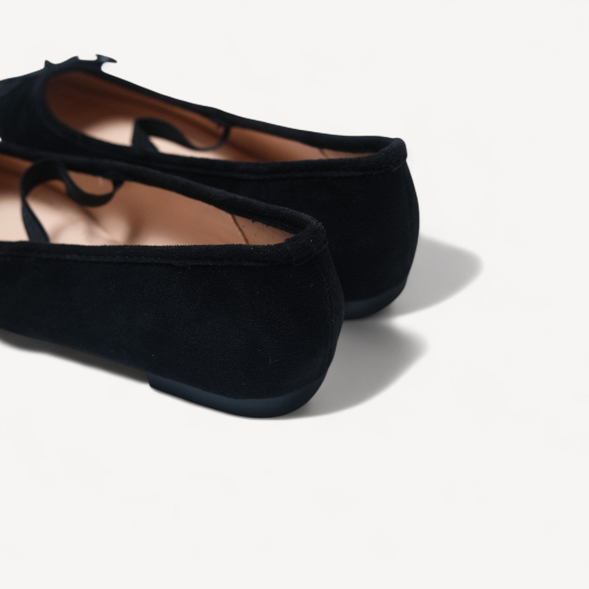 black suede almond toe flats heel detail view