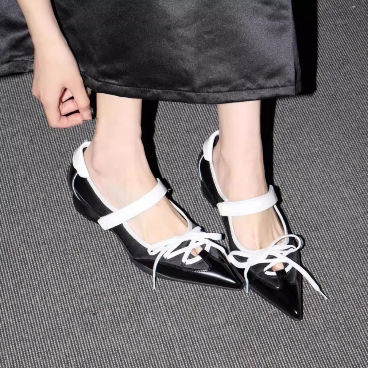black white pointed toe lace up flats model standing