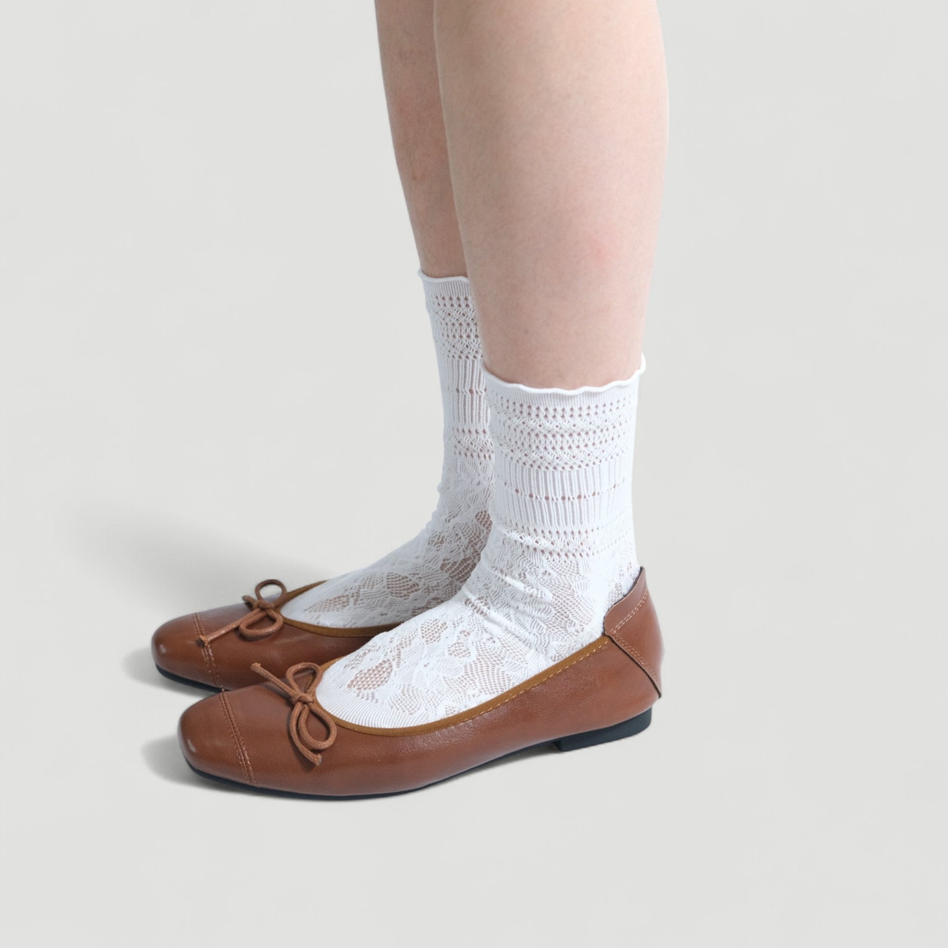 brown soft leather bow ballet flats model standing