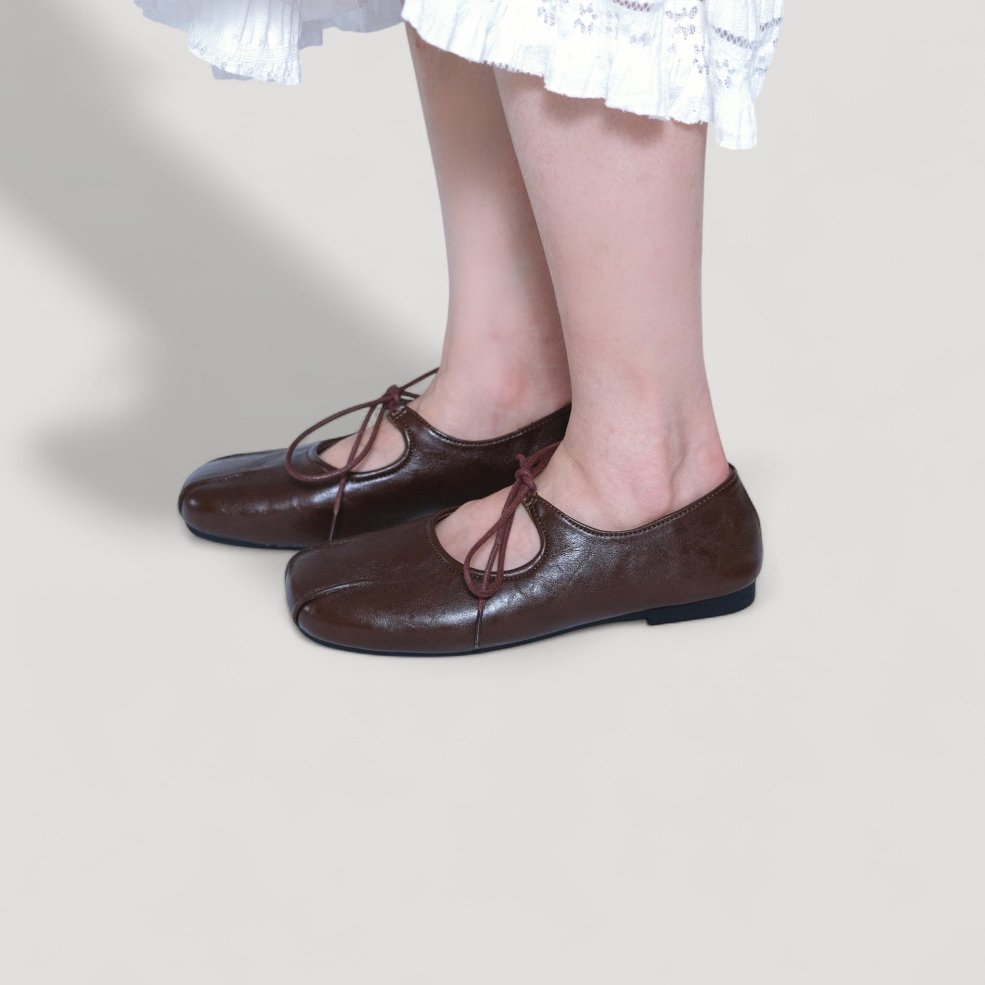 brown square toe leather lace up flats model standing