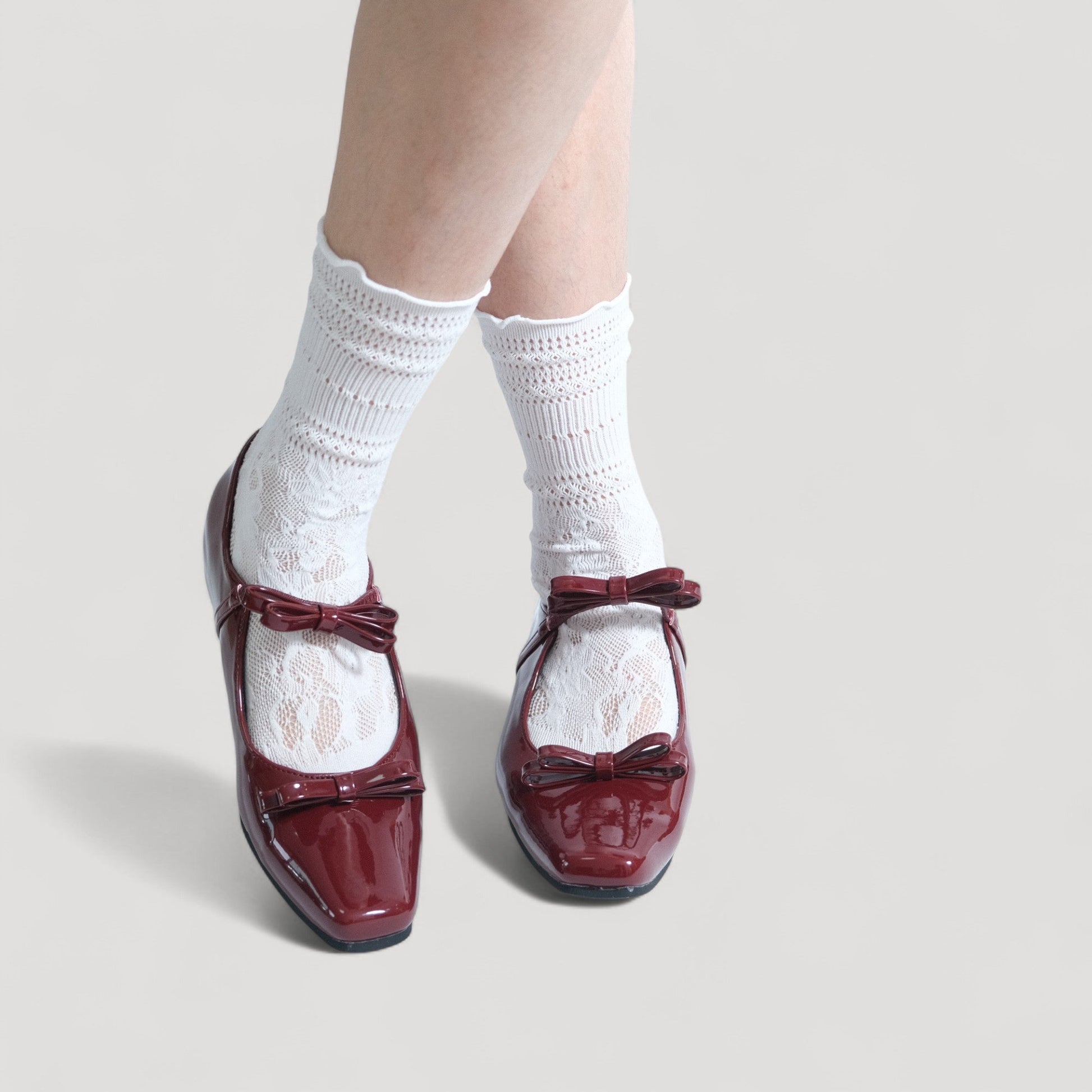 burgundy patent bow mary jane ballet flats model posing