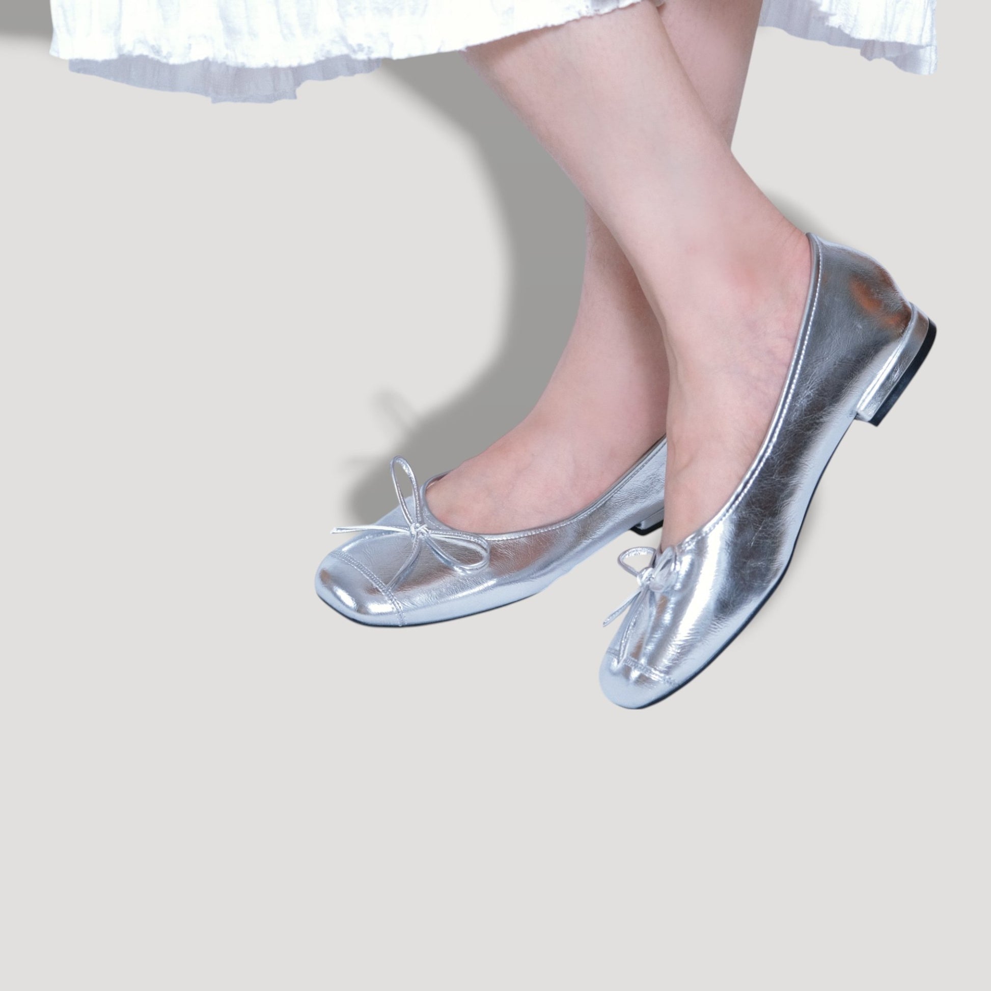 silver bow square toe ballet flats model posing view
