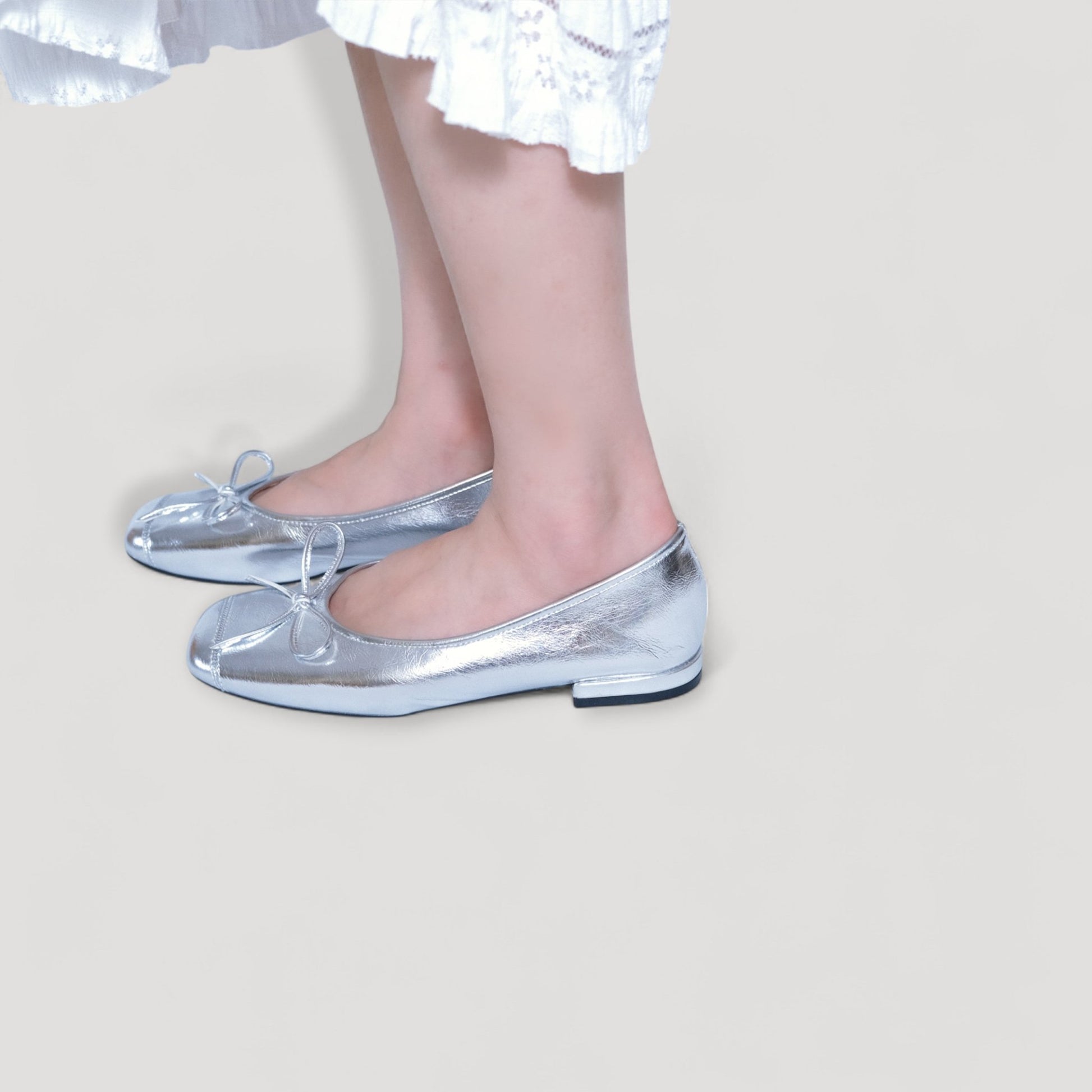 silver bow square toe ballet flats model standing view