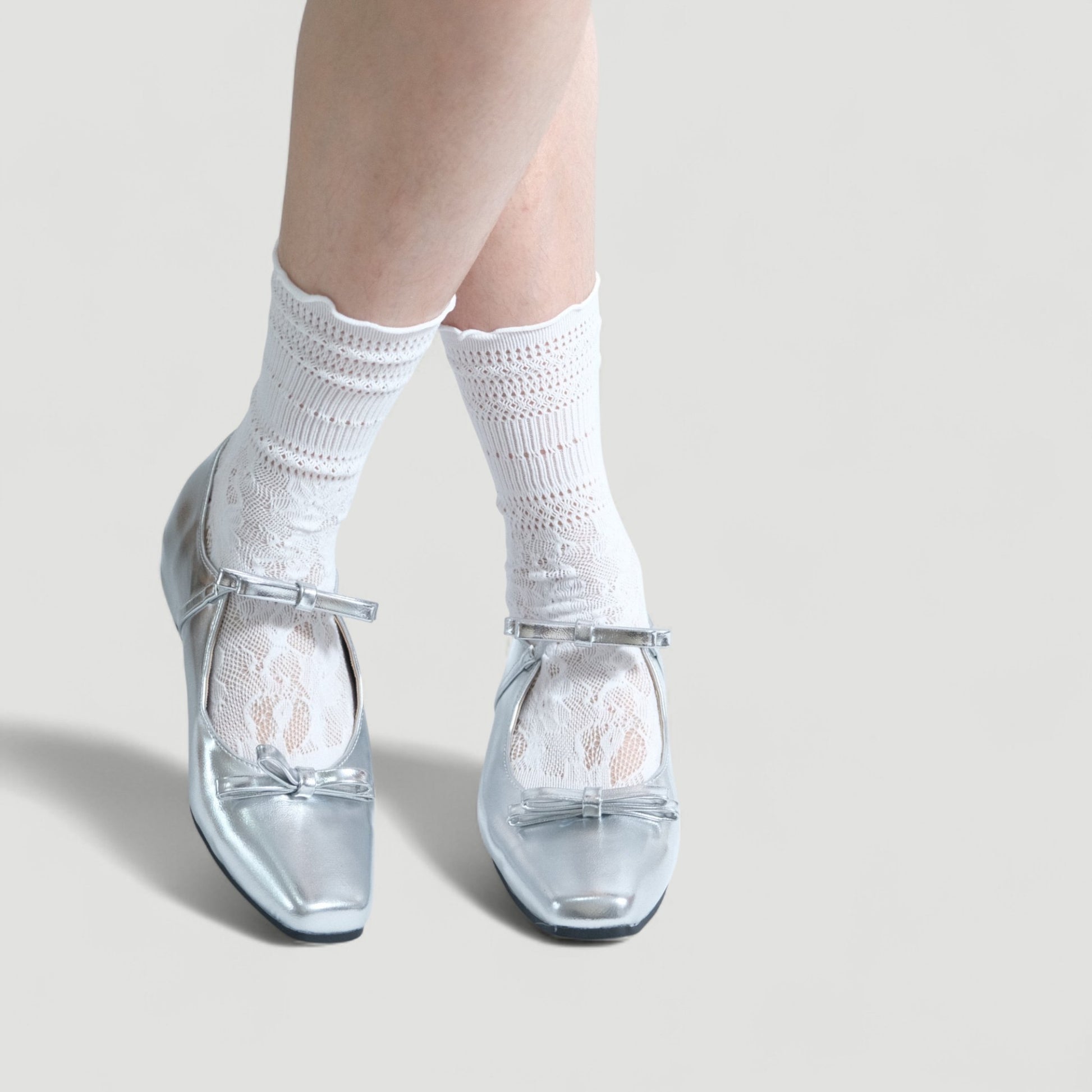 silver patent bow mary jane ballet flats model posing