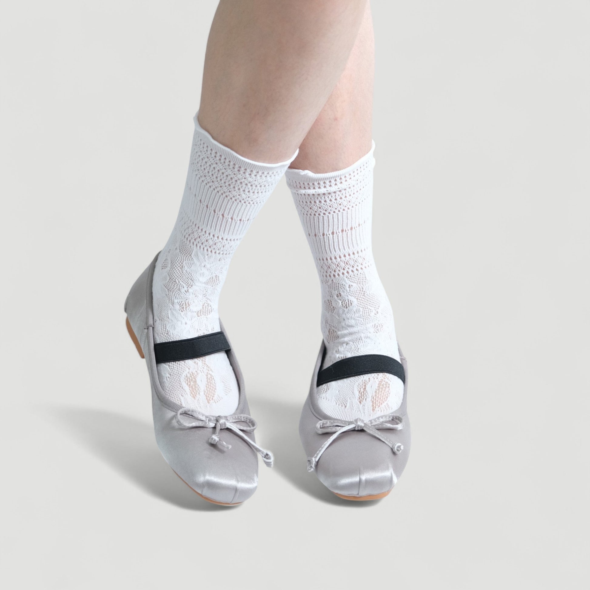 silver satin ballet flats model posing