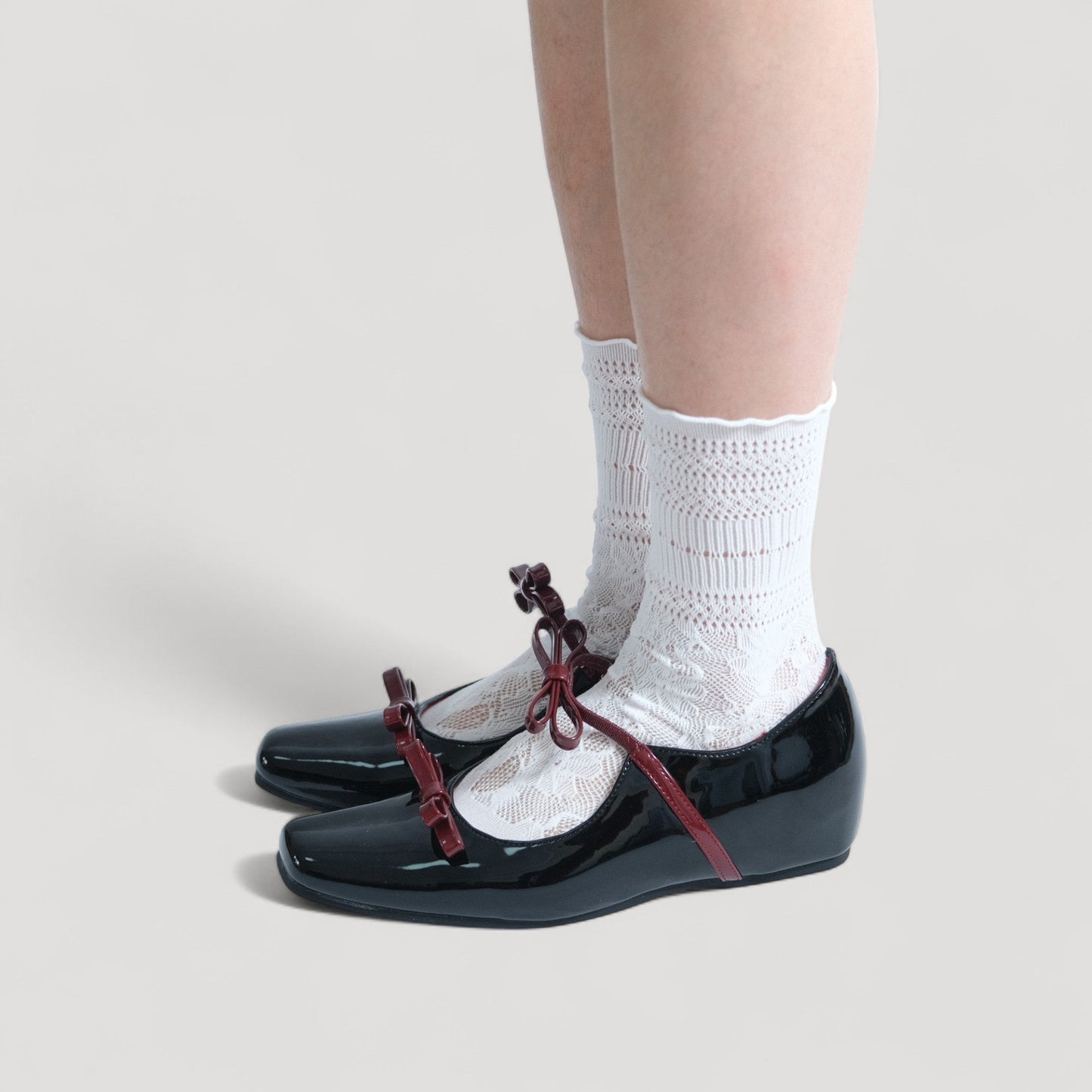 black patent mary jane bow flats model standing 