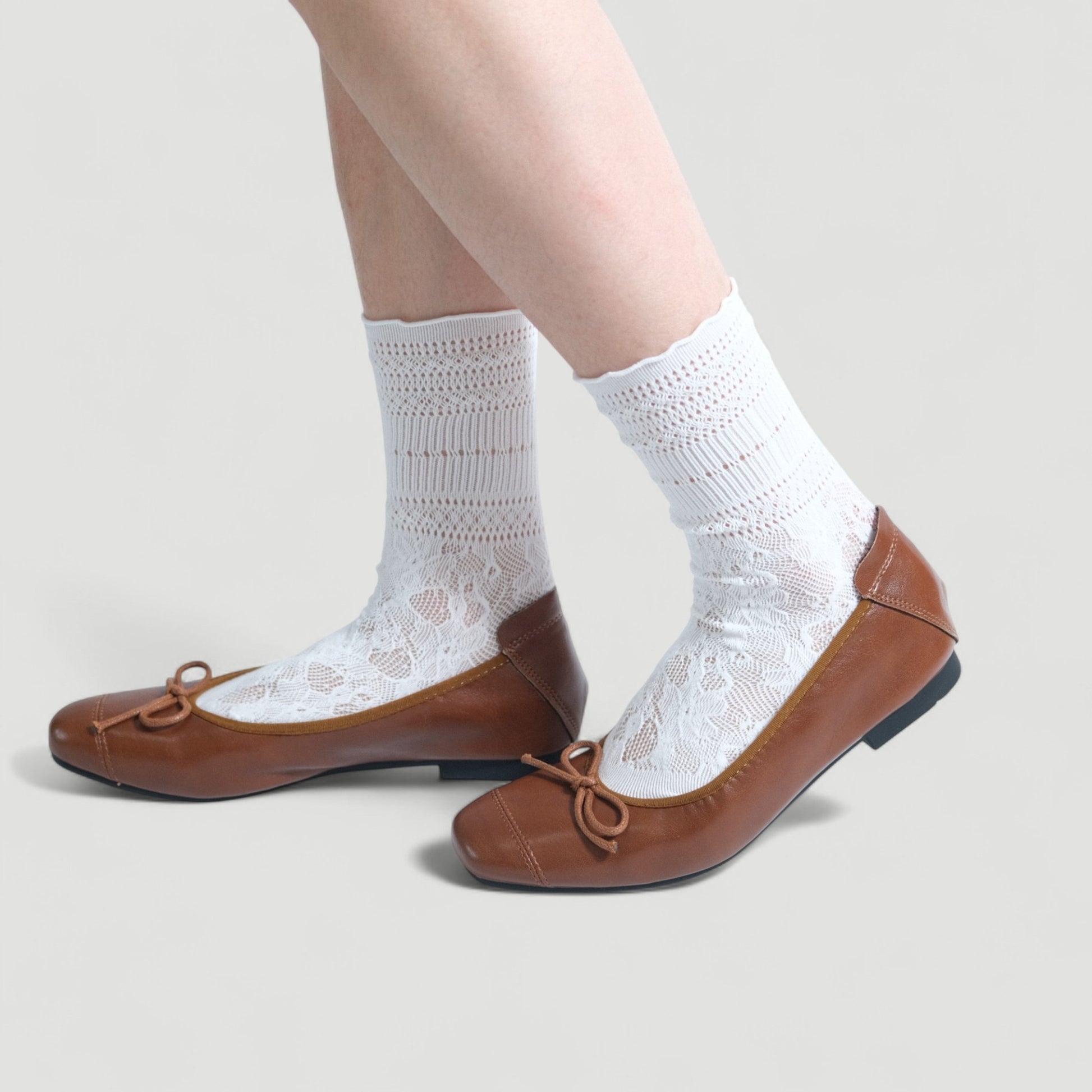 brown soft leather bow ballet flats model walking  