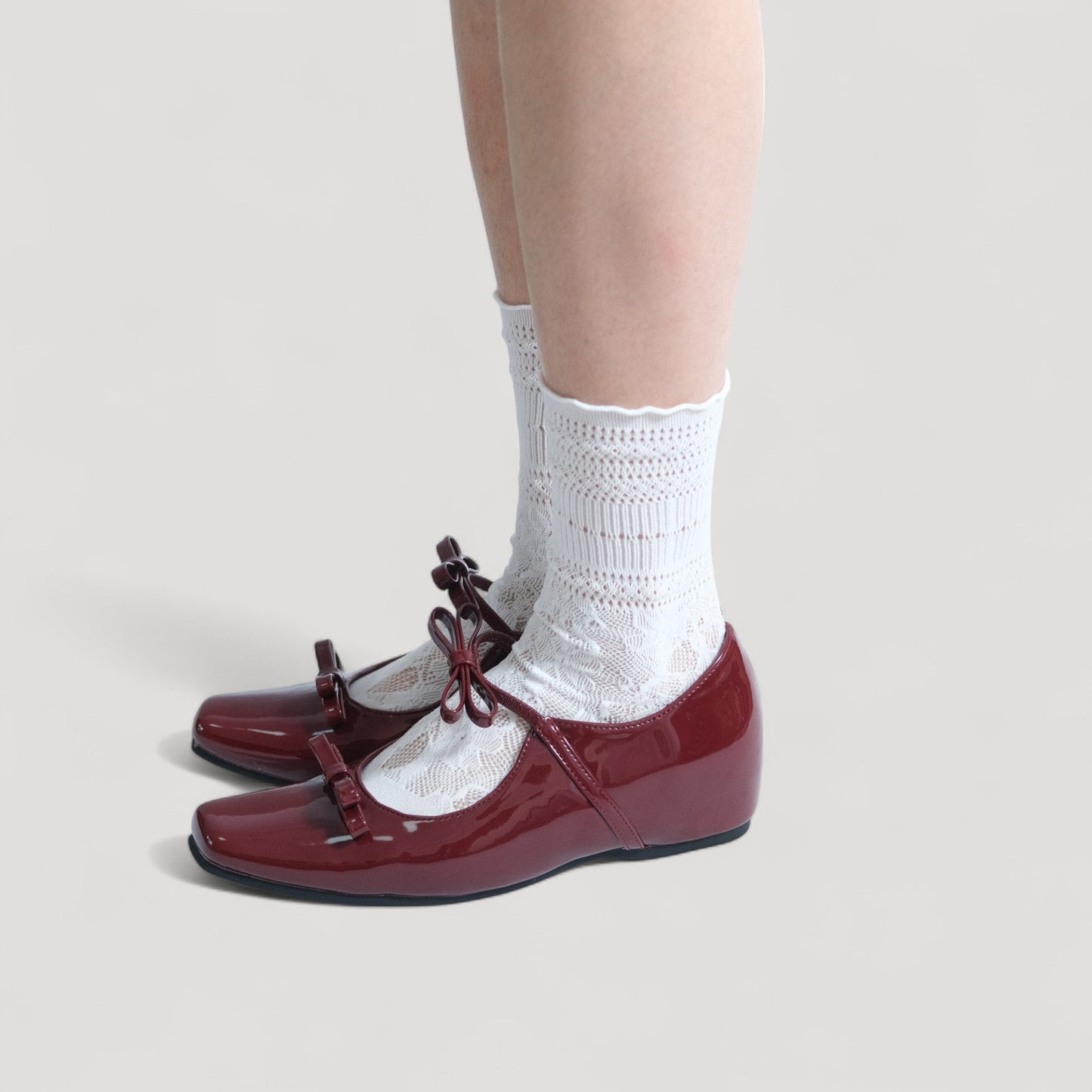 burgundy patent bow mary jane ballet flats model standing 