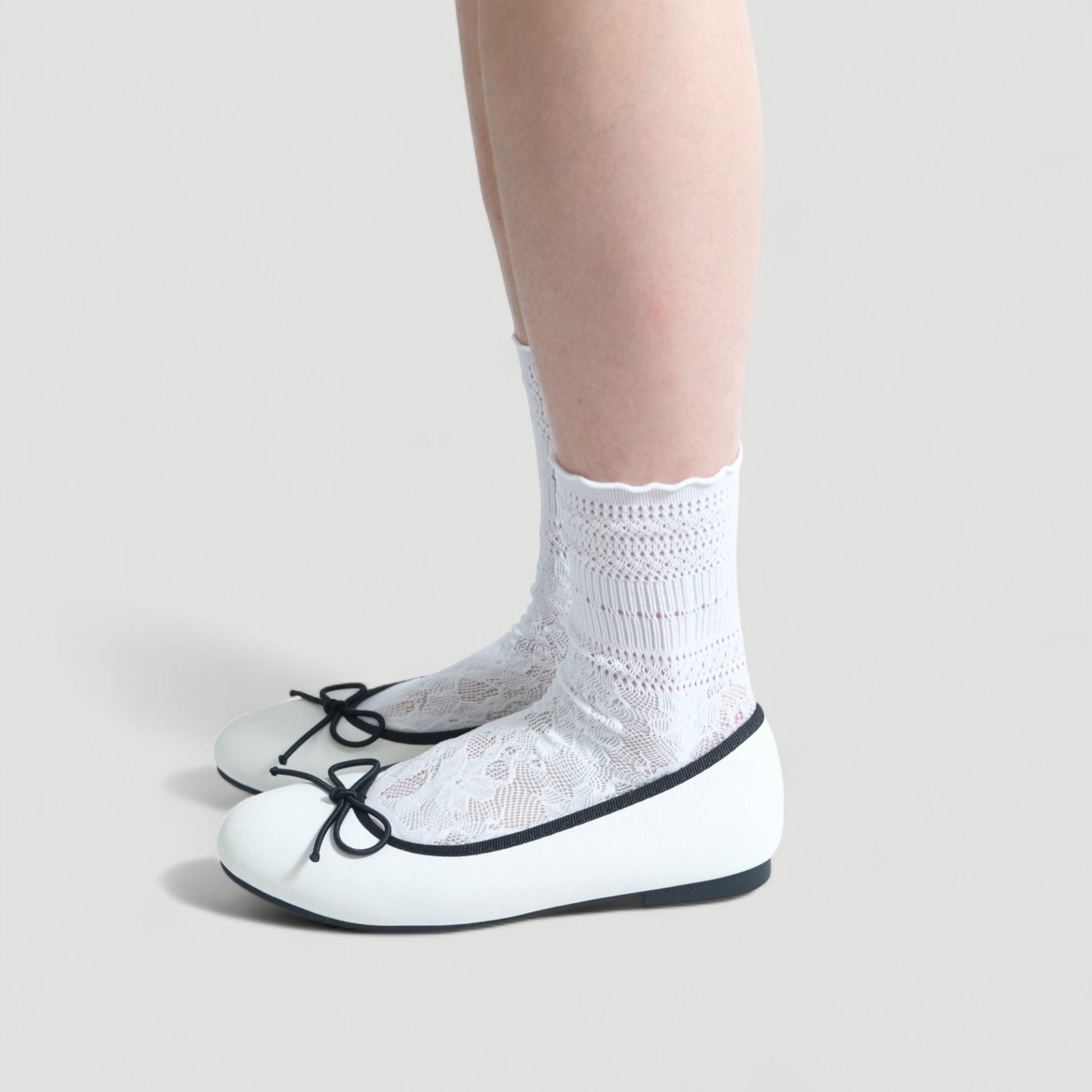 white almond toe bow ballet flats model standing 